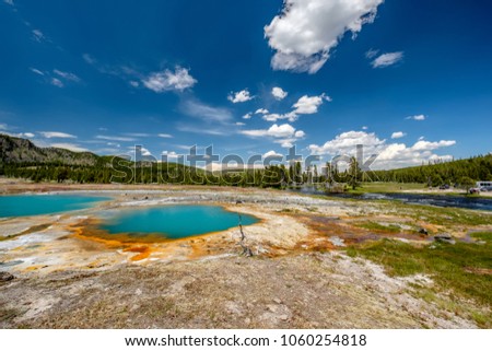 Hot thermal spring Black Opal Pool in Yellowstone National Park, Biscuit Basin area, Wyoming, USA