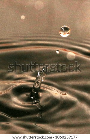 splashes and patterns on the surface of crude black oil