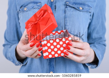 Concept of xmas, christmas, new year, valentine, anniversary, family day, gift for boyfriend, person, people, teen age. Cropped close up photo of cute beautiful gift  in hands isolated gray background