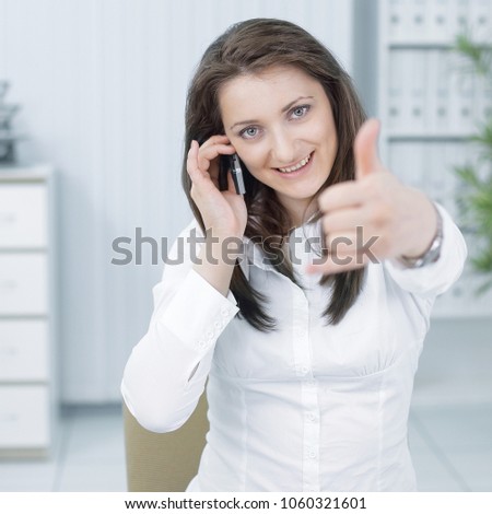 successful business woman showing thumb up,sitting at your Desk