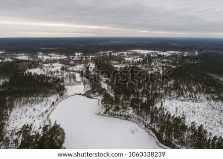 Aerial view of frozen river and dam. Winter landscape. Panorama.