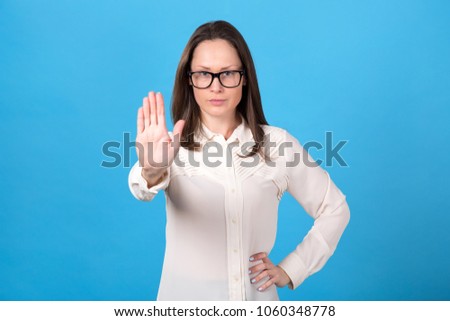 Businesswoman emotions of discontent. Woman showing a sign with his hand: no, denial, stop.