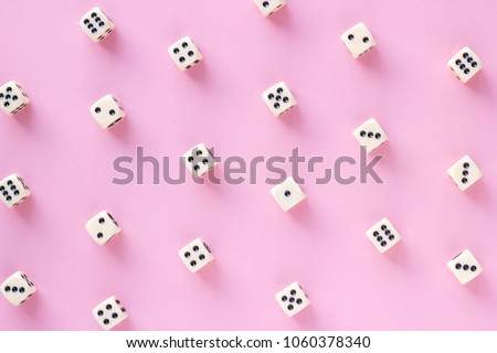 Gaming dice pattern on pink background in flat lay style. Concept for games, game board, presentation, banners or web. Top view. Close-up.