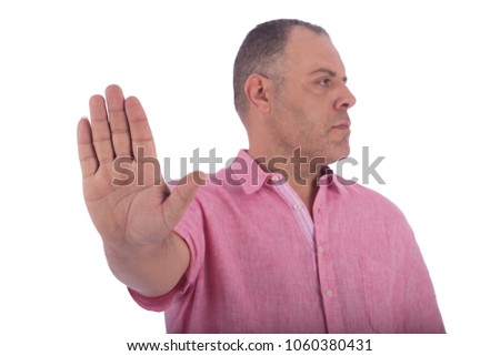 Close shot of a middle-aged man doing the stop sign by his hand to stop someone from doing something, isolated on white background
