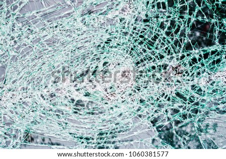 glass destroyed in thousands of cracks like a dense web of cuts