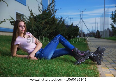 Young beautiful girl with dark hair resting after roller skating