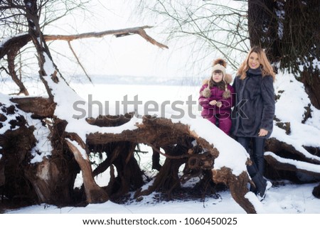 mother with her daughter in the winter