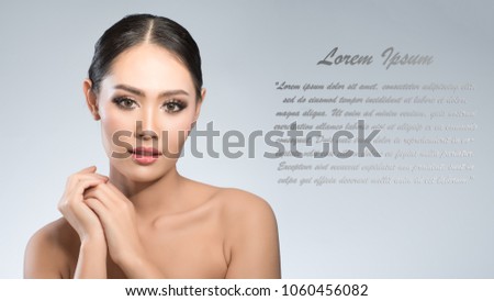 Beauty shot of young pretty asian woman with clear skin ongrey background, for skin ad and cosmetology