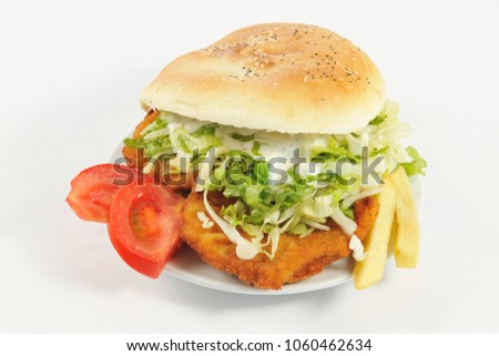 Huge sandwich. Sandwich with chicken, lettuce, tomatoes slices, mayonnaise and fries.