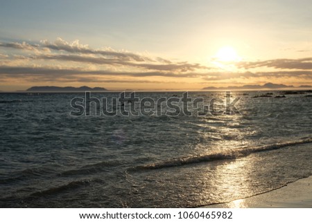 Wonderful sunset on the beach with clouds in the sky