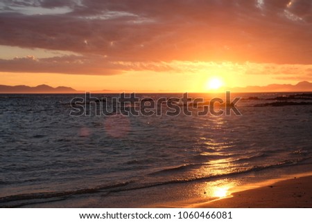 Wonderful sunset on the beach with clouds in the sky
