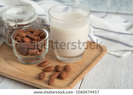 Almond milk and almonds are useful grains on wooden trays.