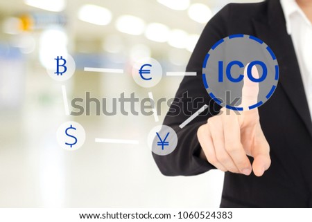 Businessman hand touching ICO, Initial Coin Offering, icon on a virtual screen over blur background, Cryptocurrency, Bitcoin and ICO Digital Electronic Trade Market Stock Index concept.