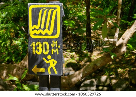 It's the information sign that tell the way to the waterfalls. It was 130 meters far from the waterfall.Thai language appeared in a picture means meter