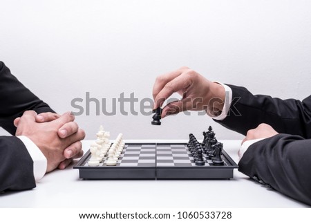 the abstract image the both of businessmen playing the chess board game and the white back drop. the concept of strategy, victory, business, win, games, intelligence and education.