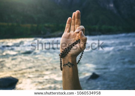 Shiva blessing. Man's hand with mudra and rudrakshi.