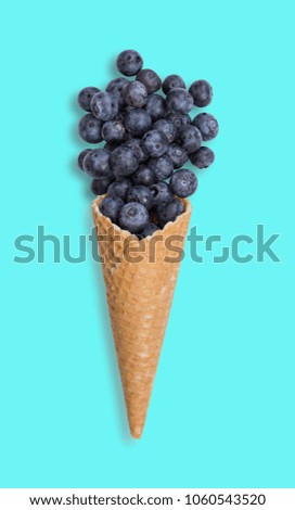 Blueberry ice cream cone with fresh fruits.