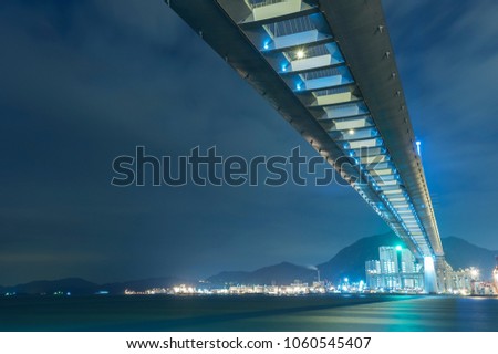 Cutterstone bridge and cargo port in Hong Kong city at night