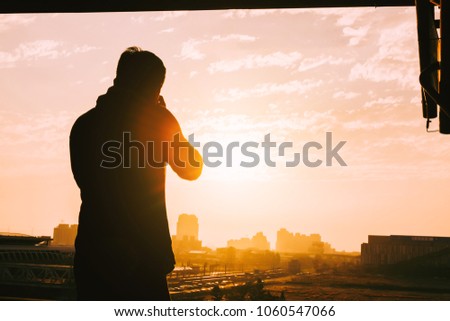 Silhouette of a woman with cityscape background.