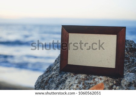 Photo frame stone, sea at sunset place for lettering, copyspace