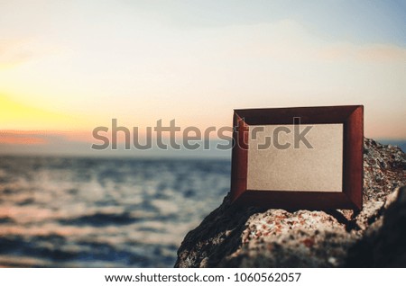 Photo frame stone, sea at sunset place for lettering, copyspace