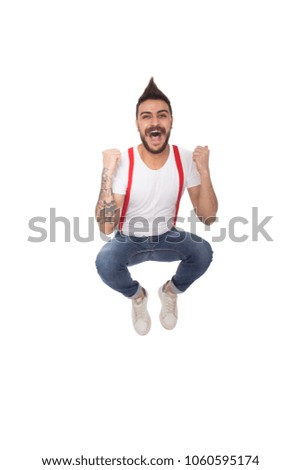 Handsome young man wearing a casual outfit, looking very happy and he is jumping up in the air, isolated on white background.