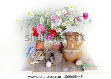 Bouquet of poppies, daisies and ceramics on the table. Still life with wild flowers.