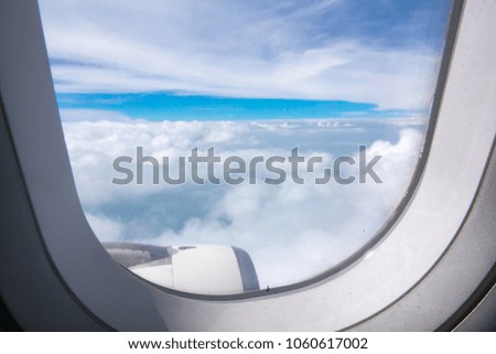 Wing airplane and sunset on sky blue or azure sky and beautiful cloud, look out window airplane feeling excited and refreshing, light sunshine through airplane window and cloud more beautiful sky view