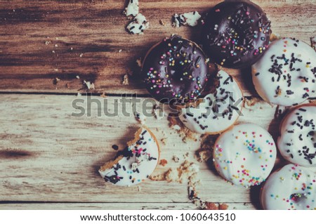 Picture of a small donuts on a wooden background. focus on donuts