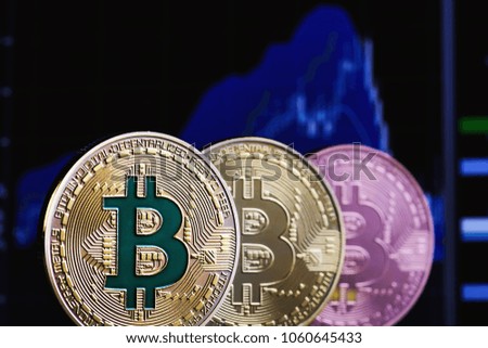Coins of bitcoins and the financial chart as background