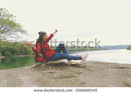 Relaxing moments, Beautiful Asian woman enjoying listen her favorite song in nature summer of vacation time. Color of Hipster Tone.