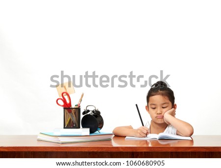 Asian little girl  back to school and happy time Cute industrious child is sitting at a desk indoors