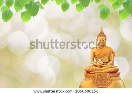 Statue Buddha and bodhi leaf on bokeh background, religion background, buddhism background.