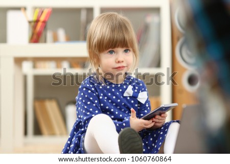 Cute little girl on floor carpet use cellphone calling mom portrait. Life style apps social web network wireless ip telephony concept