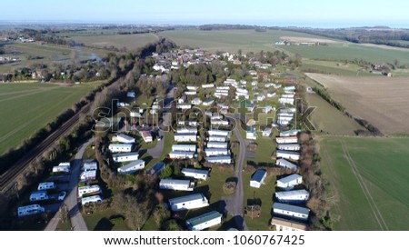 Aerial picture of campsite or camping pitch place used for overnight stay in outdoor area showing the places divided into pitches where people can camp overnight using camper vans or caravans
