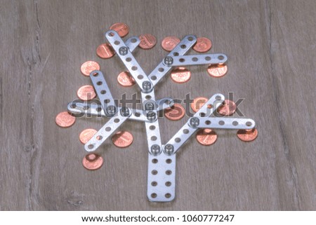 the financial tree of prosperity: metal plant with copper coins on a dark wooden background, short focus