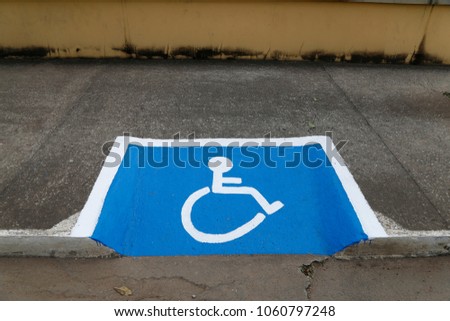 International symbol for wheelchair users designed on sidewalk
