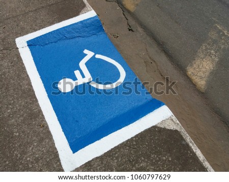 International symbol for wheelchair users designed on sidewalk