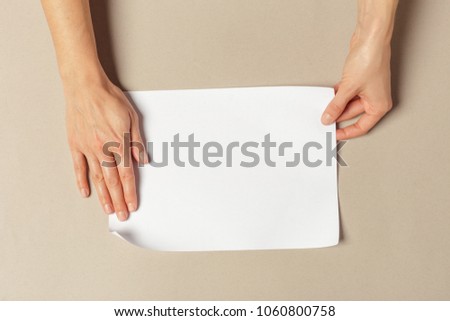 Hand holding papers a4 size