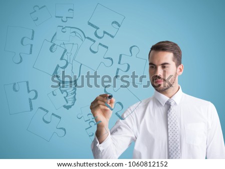 Business man drawing jigsaw doodle against blue background