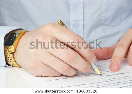 hand of businessman with pen, signing agreement