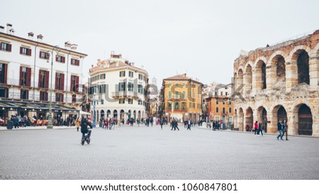 Blurred cityscape with people on central square in Verona.