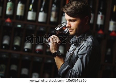 Bokal of red wine on background, male sommelier appreciating drink Royalty-Free Stock Photo #1060848260