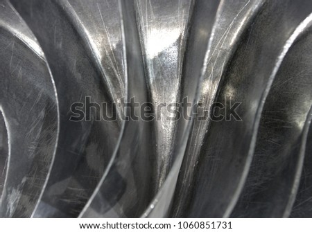 Abstract metallic background created by turbine blades and light, image with local focus and blur