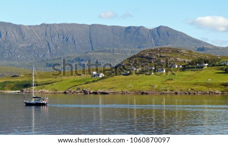 Beautiful sunny shores of the highlands just outside the town of Ullapool in Scotland. Royalty-Free Stock Photo #1060870097