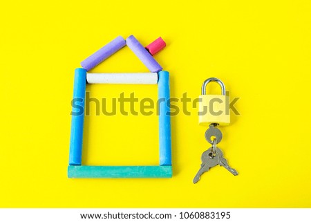 model of house as symbol on yellow background, house make in chalk with lock and keys on a board, get the key from home, building, shopping, office, concept of buying a house,