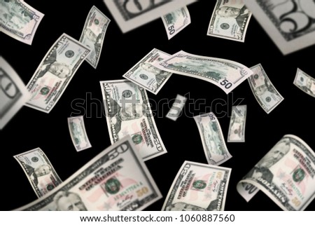 Flying 50 American dollar banknotes, isolated on black background