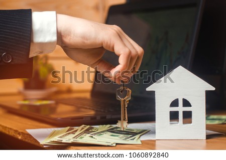 The hand holds the keys to the house. concept of real estate. sale or rental of housing, apartment rental. realtor