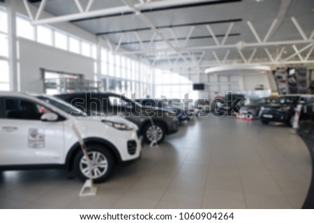 Auto showroom, dealer talking with buyer. Electro cars in moderm vehicle salon. Royalty-Free Stock Photo #1060904264