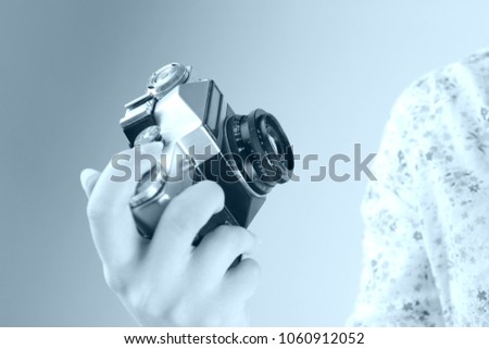 A camera in the hand, Photographer, Hipster or an Old camera, Retro photography